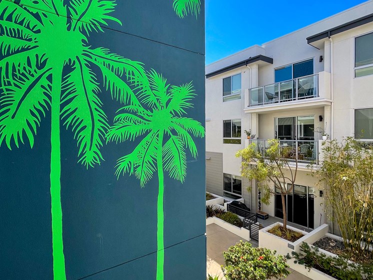 exterior building image with palm tree mural